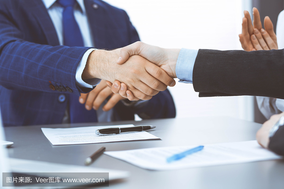 商人們握手,完成一份文件簽名。會(huì)議、合同及律師咨詢理念
